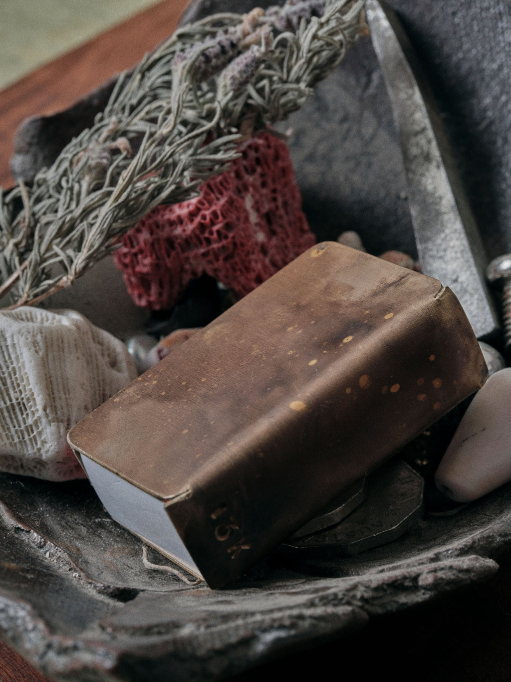 Patina brass matchbox holder handmade by 13 Knives resting in a ceramic dish with dried botanicals and objects in melbourne australia