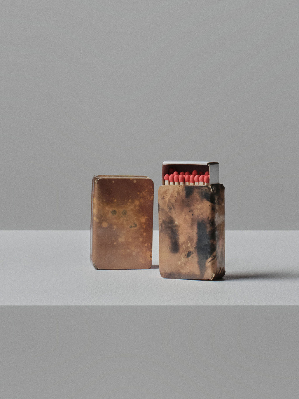 Handmade brass matchbox holder by 13 Knives Melbourne with natural patina, shown with matches